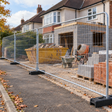 Eco Heras fencing along the pavement outside a house extension